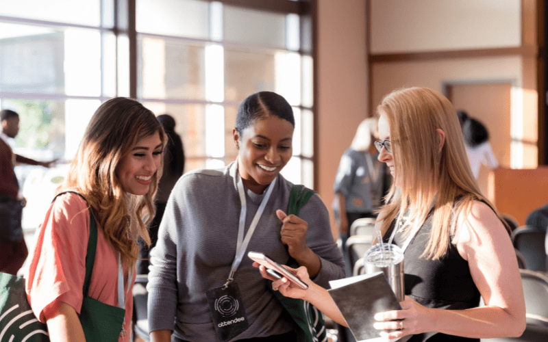 Attendees signing up for email marketing in a networking event