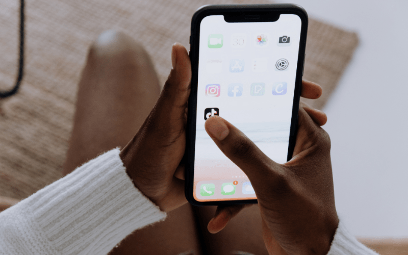 A marketing influencer accessing TikTok on their smartphone