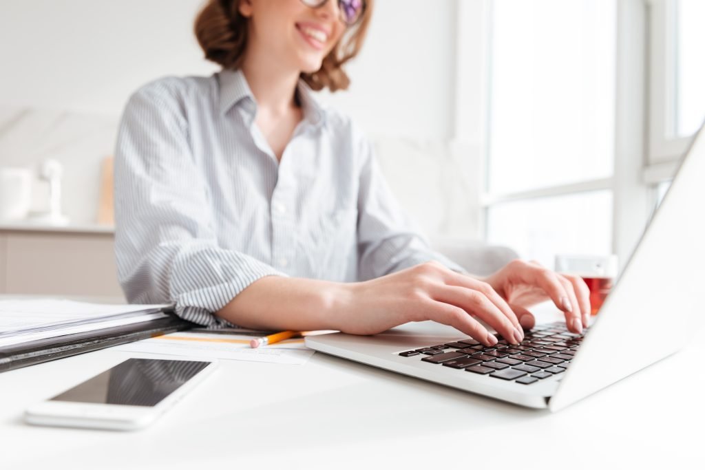 A woman on a laptop performing search engine optimisation for a UK website