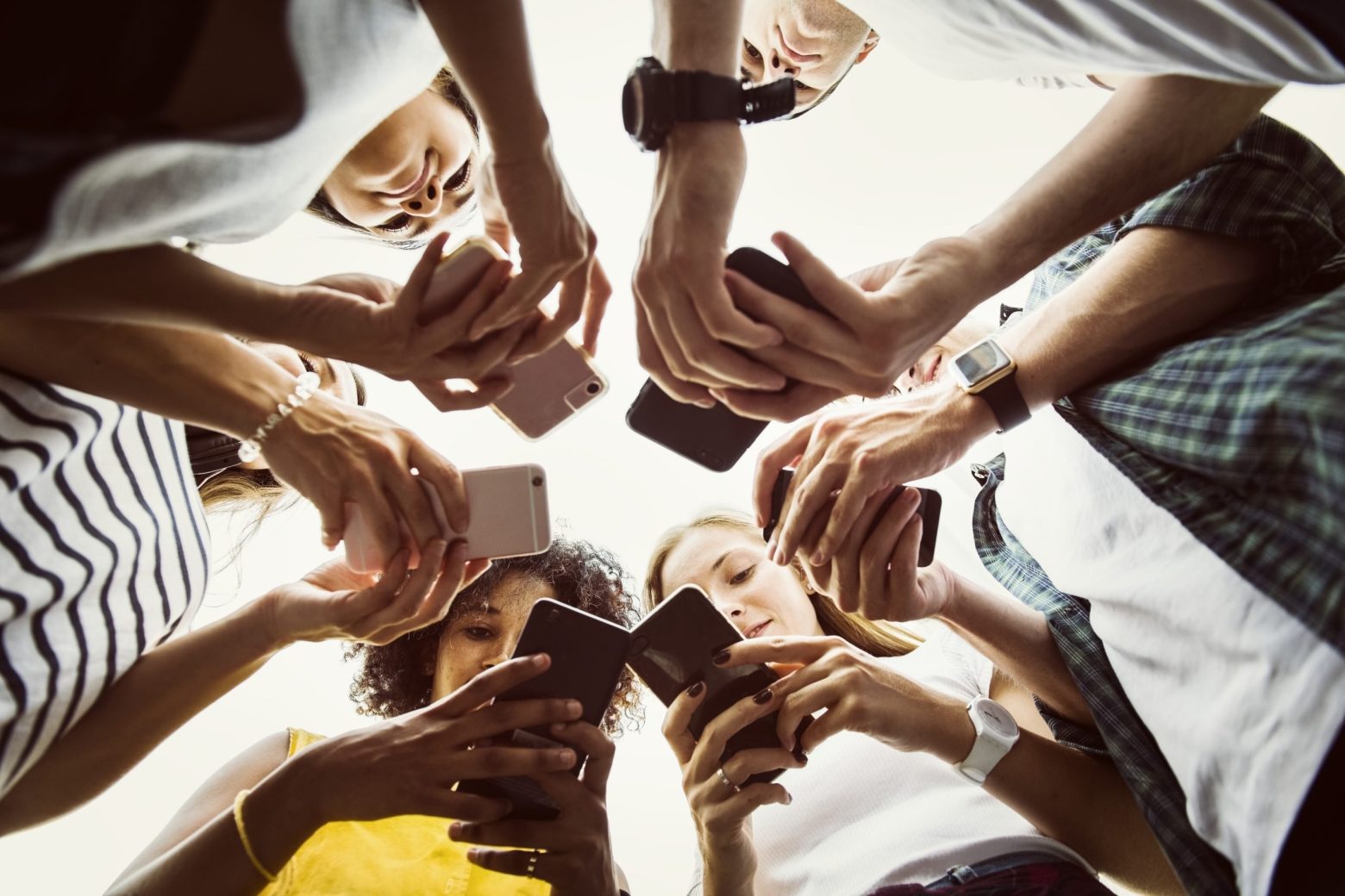 A group of people looking at social media ads on their phones